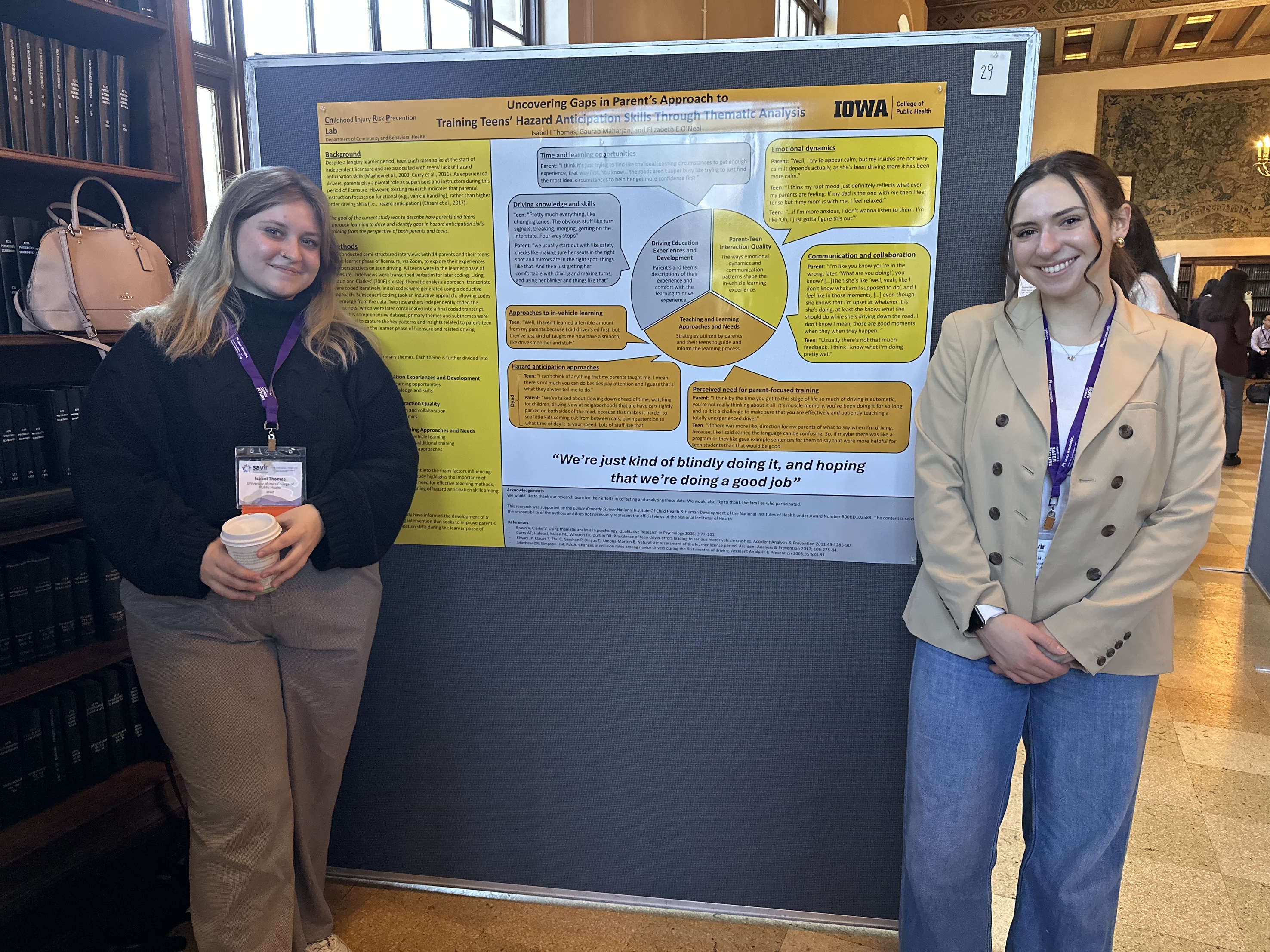 Presenters posing by poster